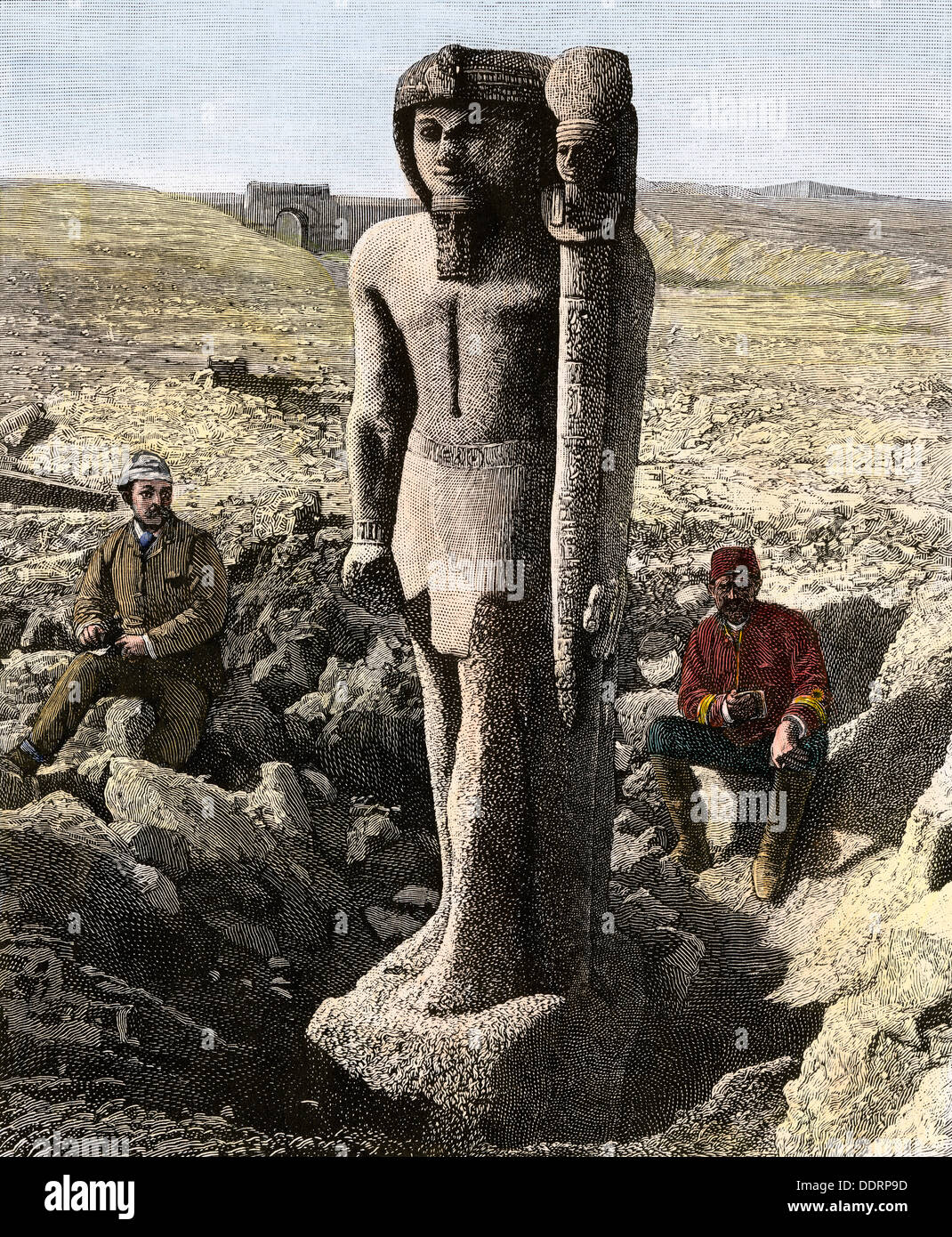 Archaeologist excavating a statue of Rameses II in Egypt, late 1800s. Hand-colored woodcut Stock Photo