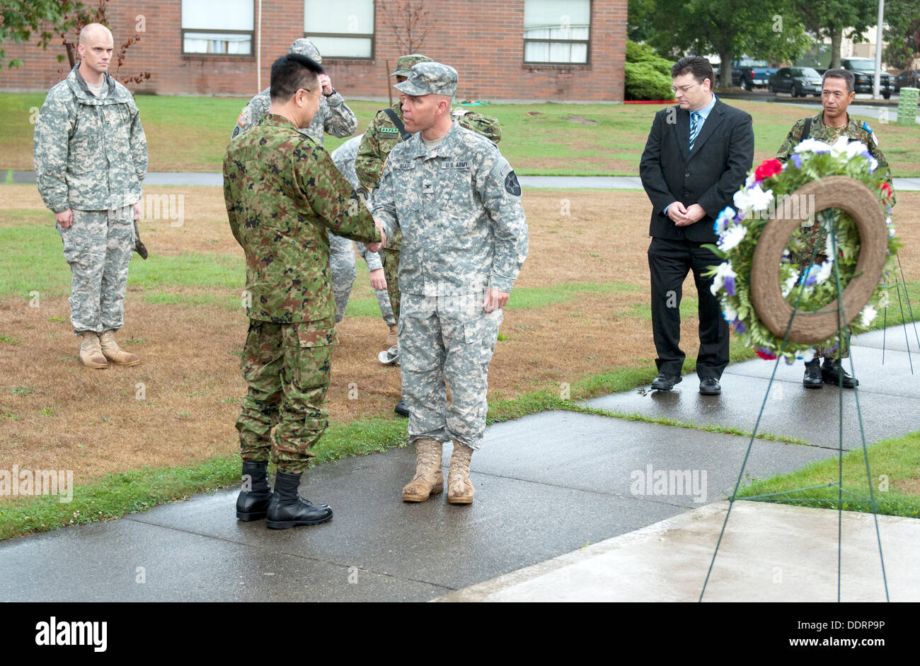 Maj. Gen. Omori (left), deputy commanding general, 4th Division, Northern Army, Japanese Ground Self-Defense Force, bids farewell to Col. Hugh D. Bair, commander, 3rd Stryker Brigade Combat Team, 2nd Infantry Division, at the conclusion of a wreath laying Stock Photo