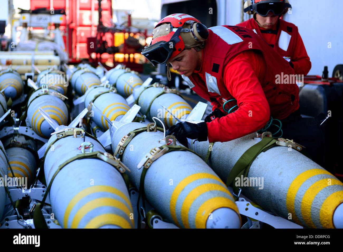 U.S. Navy Aviation Ordnanceman Airman August Moss inspects training ordnance aboard the aircraft