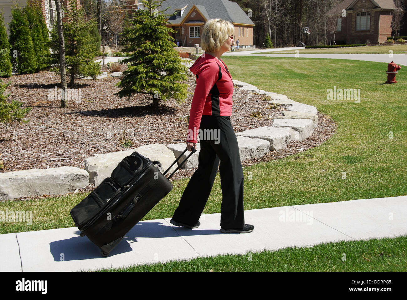 Female with suitcase Showing the concept of pulling and pushing pull