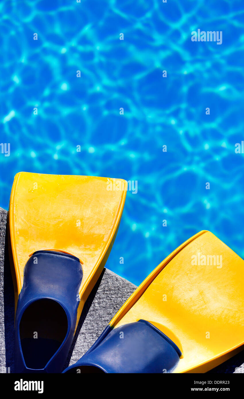 yellow fins on feet at edge of blue swimming pool Stock Photo Alamy