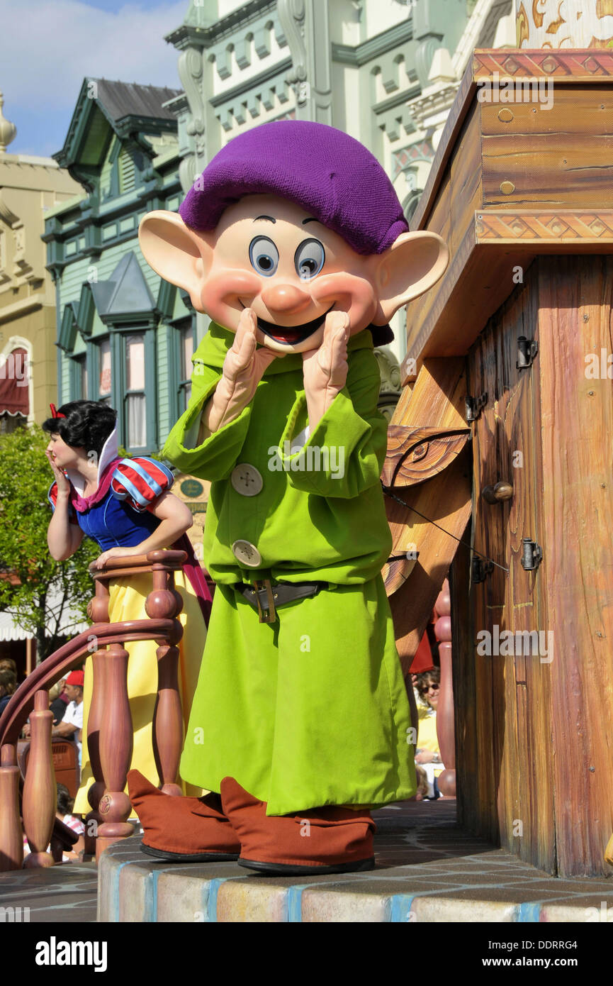 Dopey the Dwarf in parade at Walt Disney Magic Kingdom Theme Park Orlando Florida Central Stock Photo