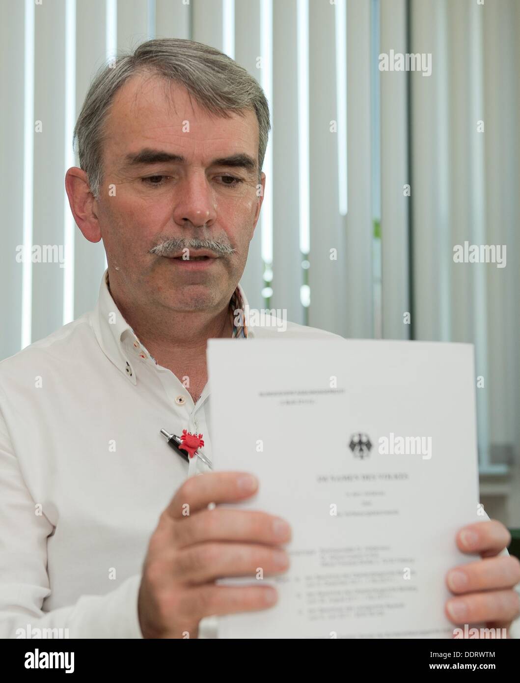 Gustl Mollath presents a verdict of the Federal Constitutional Court during an interview with the German Press Agency dpa in an office of the dpa in Nuremberg, Germany, 05 September 2013. According to the Federal Constitutional Court in Karlsruhe, it was a violation against basic law that Mollath was institutionalised into a psychiatry in the recent two years. Mollath objected against the institutionalisation and his objection was sutained. Photo: TIM SCHAMBERGER Stock Photo