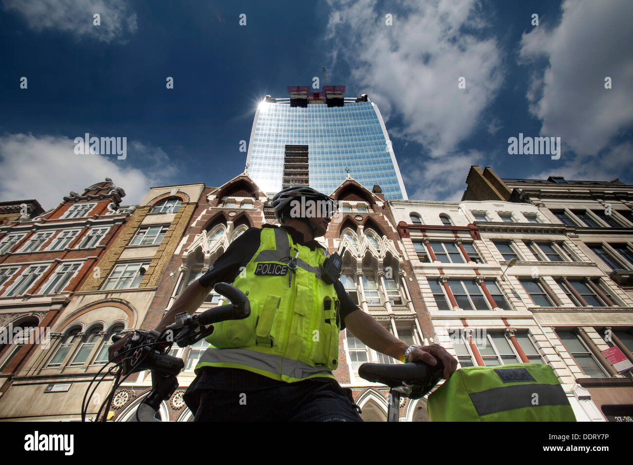 Walkie Talkie building in London that caused heat spot from concentric design policeman on bicycle Stock Photo