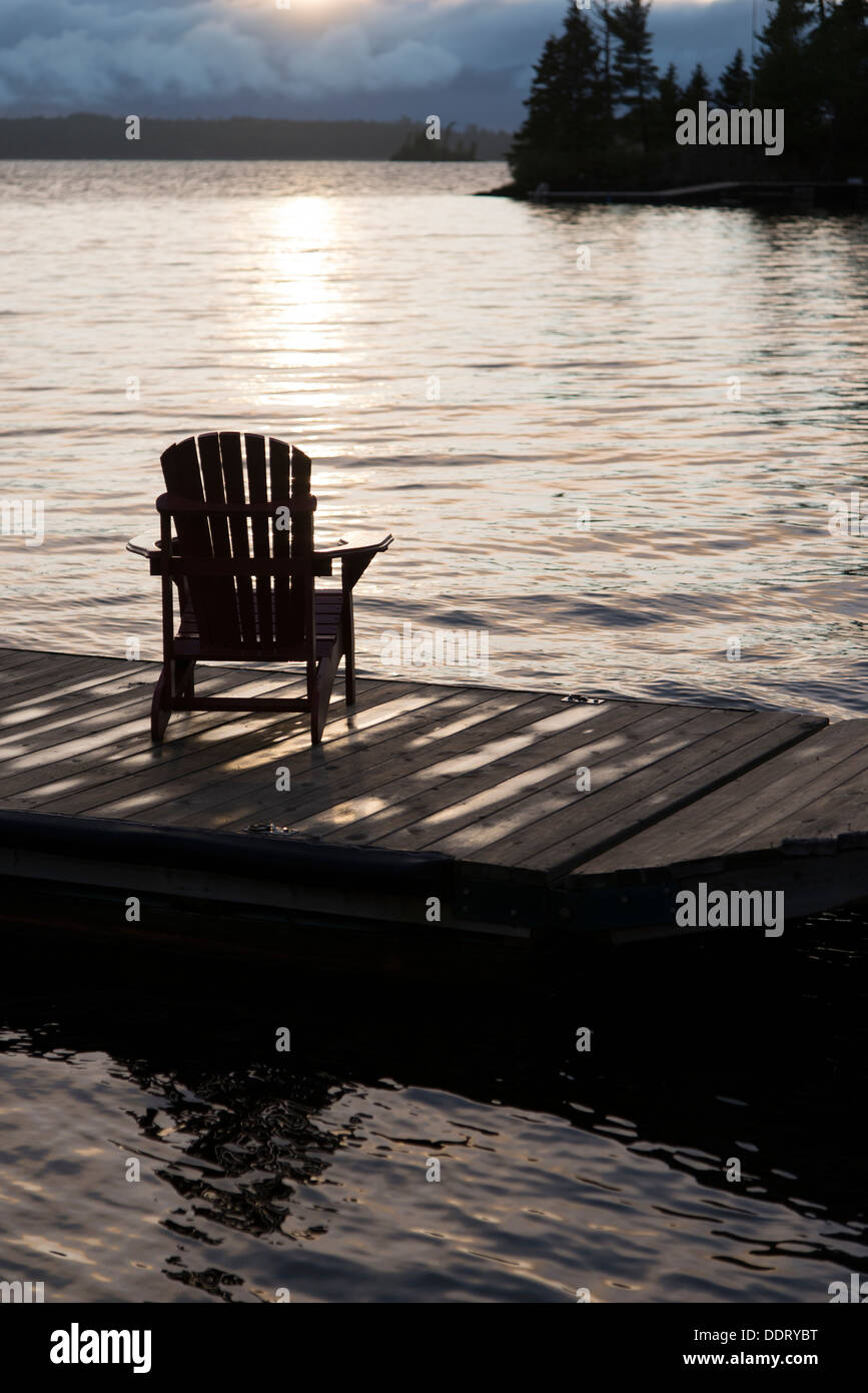 Adirondack chair on a dock at the Lake of The Woods, Keewatin, Ontario ...