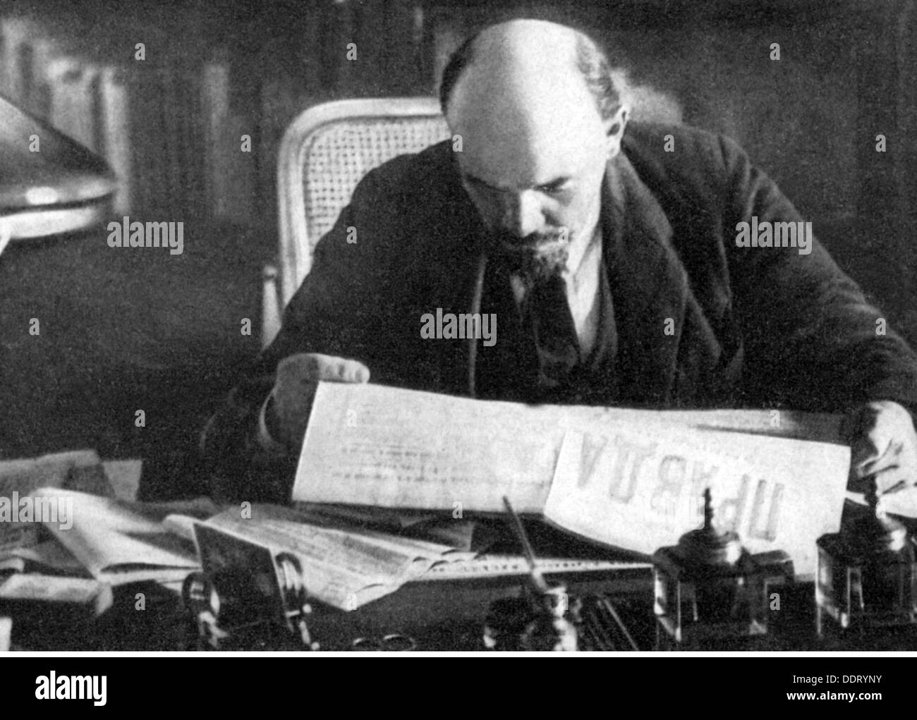 Lenin (Vladimir Ilyich Ulyanov), 22.4.1870 - 21.1.1924, Russian politician, half length, reading the 'Pravda', study, Kremlin, Moscow, October 1918, Stock Photo