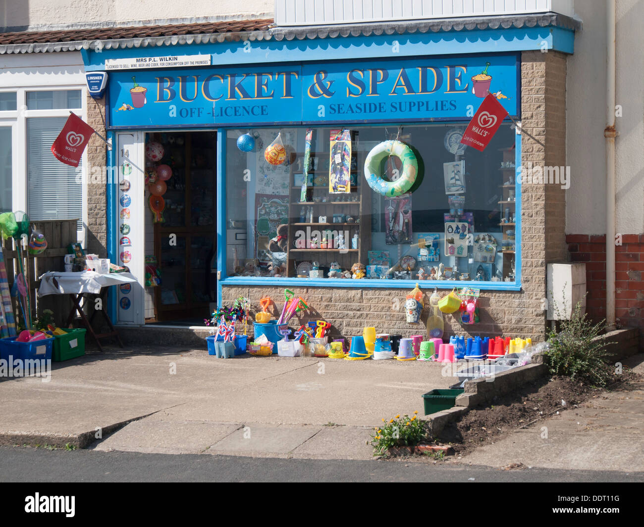 A single shop in a row of residential houses selling Buckets and Spades