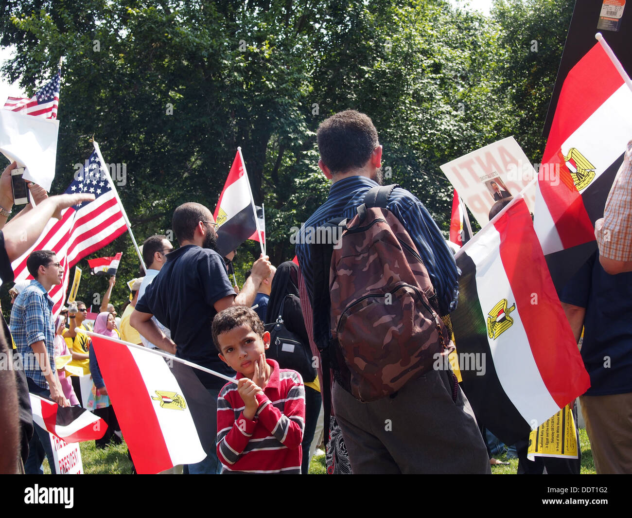 Young boy waves an Egyptian flag during a Muslim Brotherhood protest rally in Lafayette Park, Washington, D.C., August 31, 2013 Stock Photo