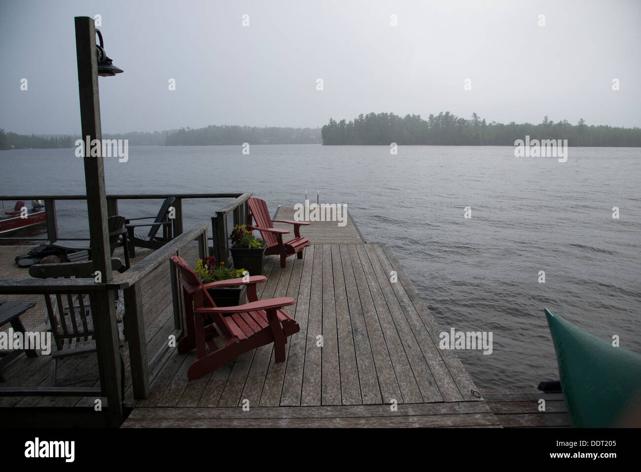 Adirondack chairs on a dock at Lake Of The Woods, Keewatin, Ontario ...