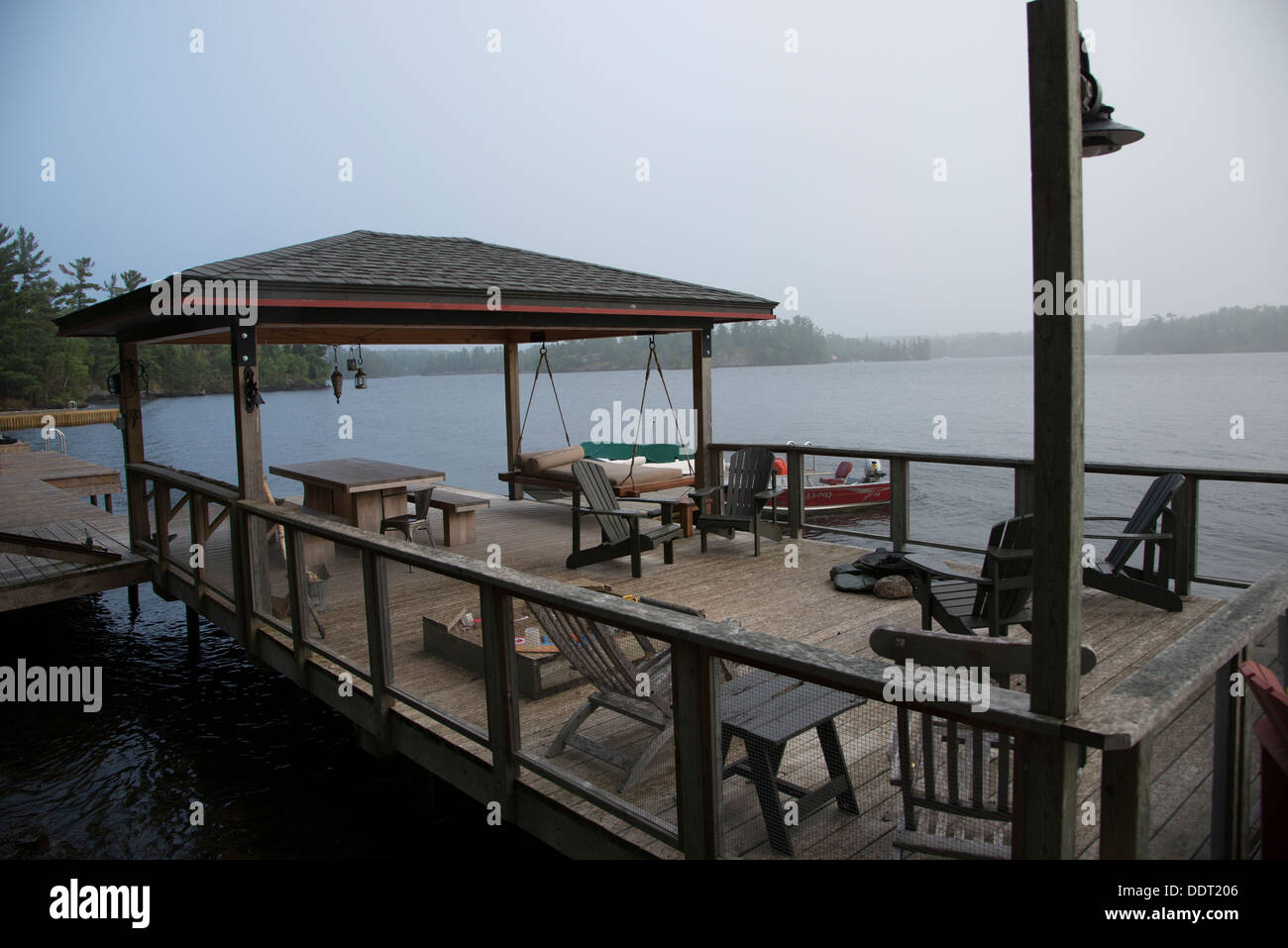 Adirondack chairs on a dock at Lake Of The Woods, Keewatin, Ontario ...