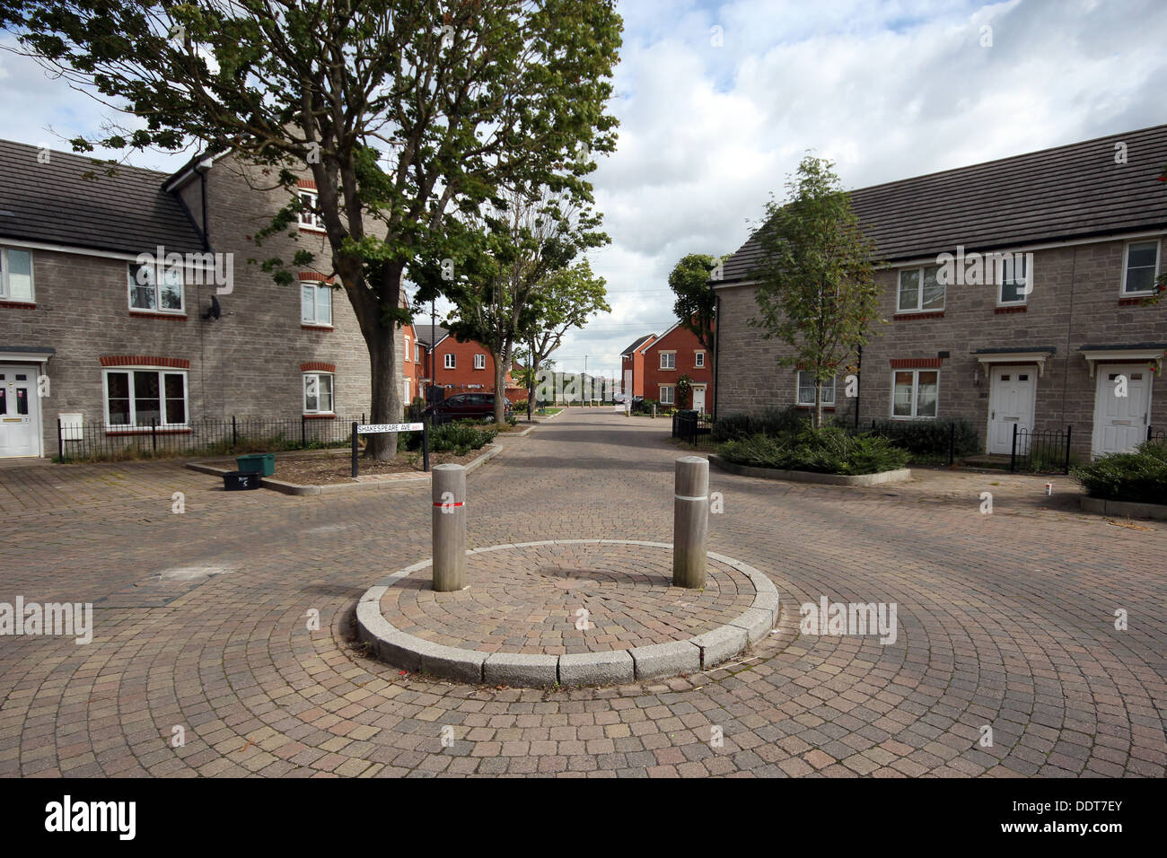A mini roundabout on a cobbled street in a new housing estate, Bristol, UK. Stock Photo