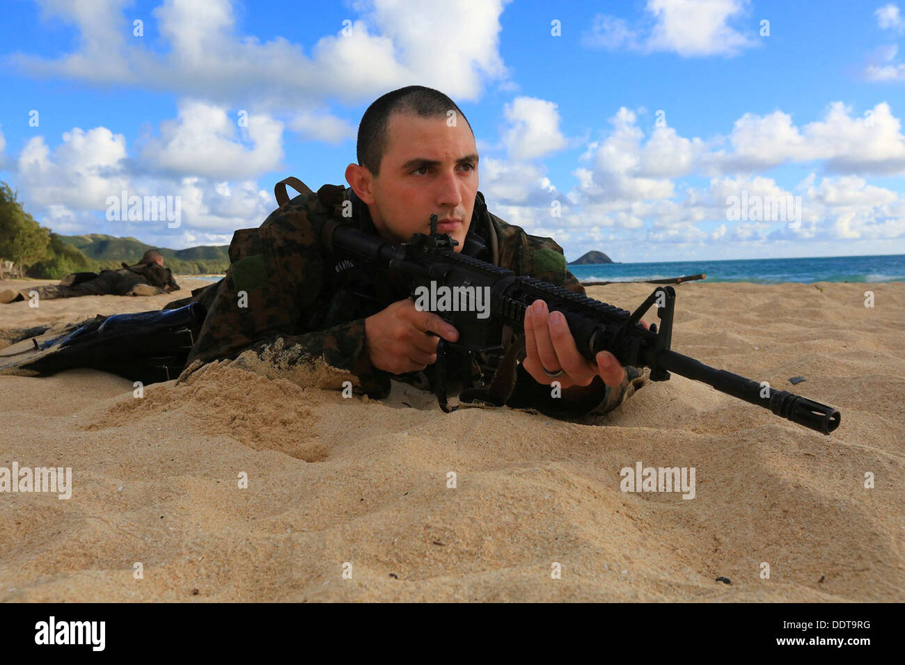 A US Marine special operations Force Reconnaissance commando wade ashore at Bellows Beach during sustainment training August 31, 2013 on Oahu, Hawaii. Stock Photo