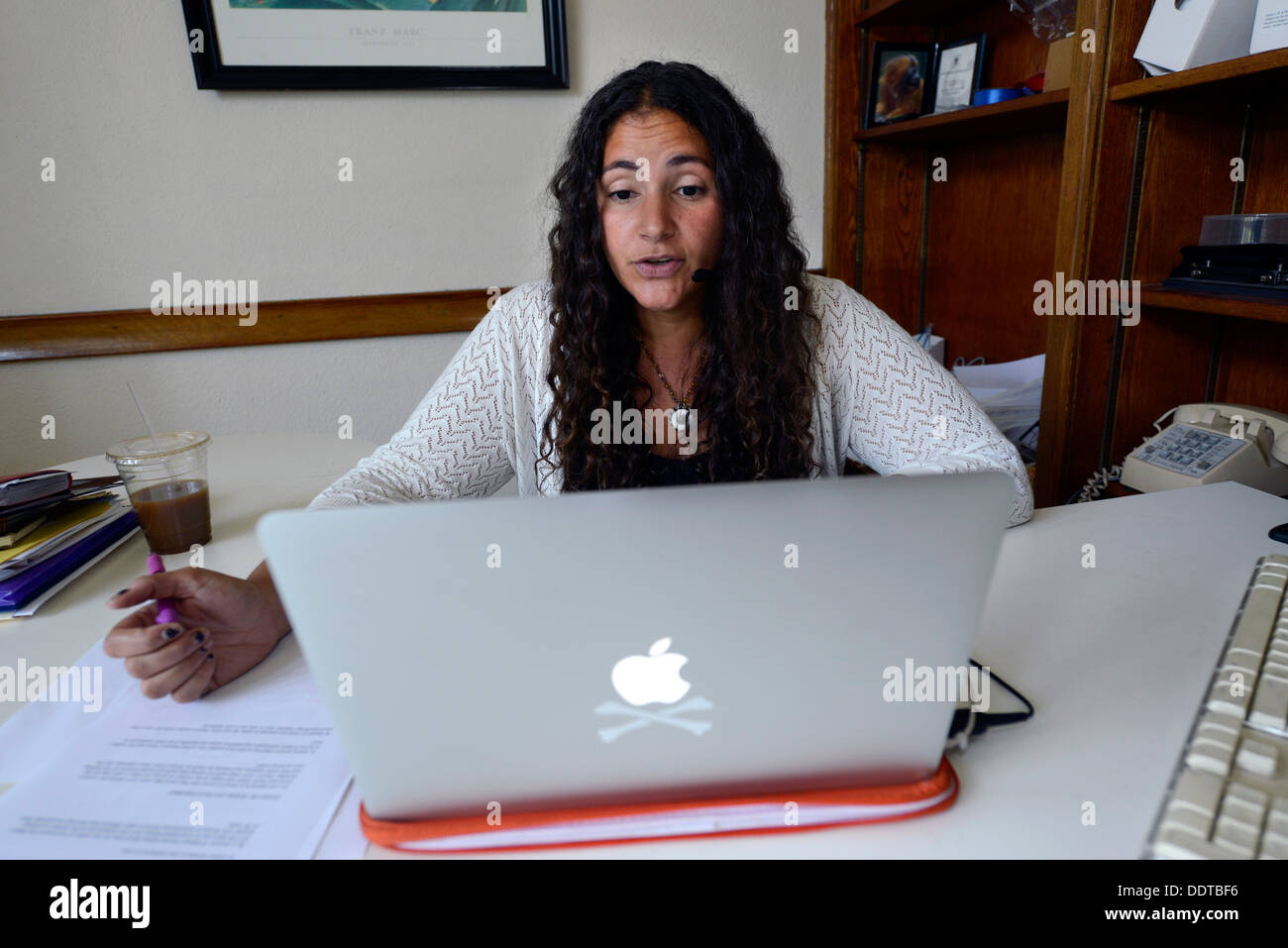 Yale psychology professor Laurie Santos teaches a class section online from her office. Yale is making a big online push. Stock Photo