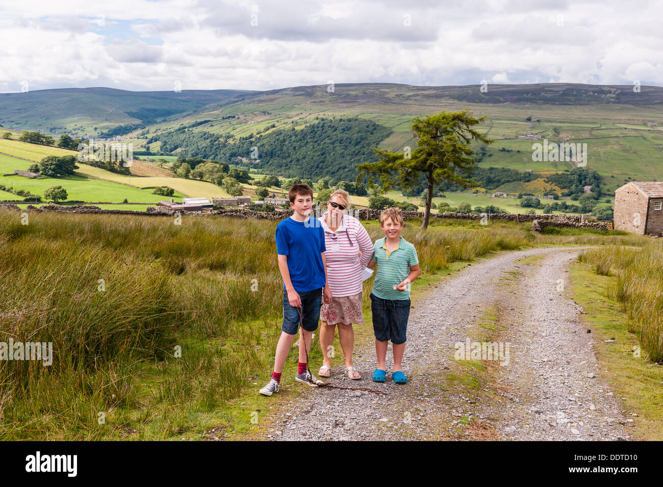 A mother and her 2 sons out on a family walk in Swaledale , North Yorkshire , England , Britain , Uk Stock Photo