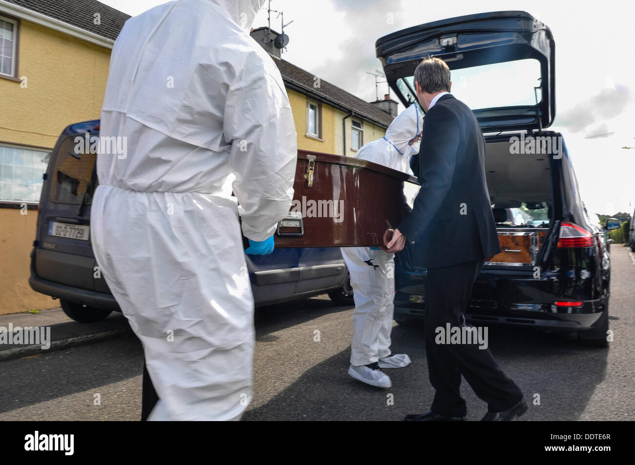 Bailieborough, County Cavan, Republic of Ireland, 6th September 2013 - Two forensics officers and undertakers load a coffin into the waiting hearse outside the home of 54 year-old Patricia Kierans where her body was discovered to the waiting hearse.  She had been  'violently murdered' Credit:  Stephen Barnes/Alamy Live News Stock Photo