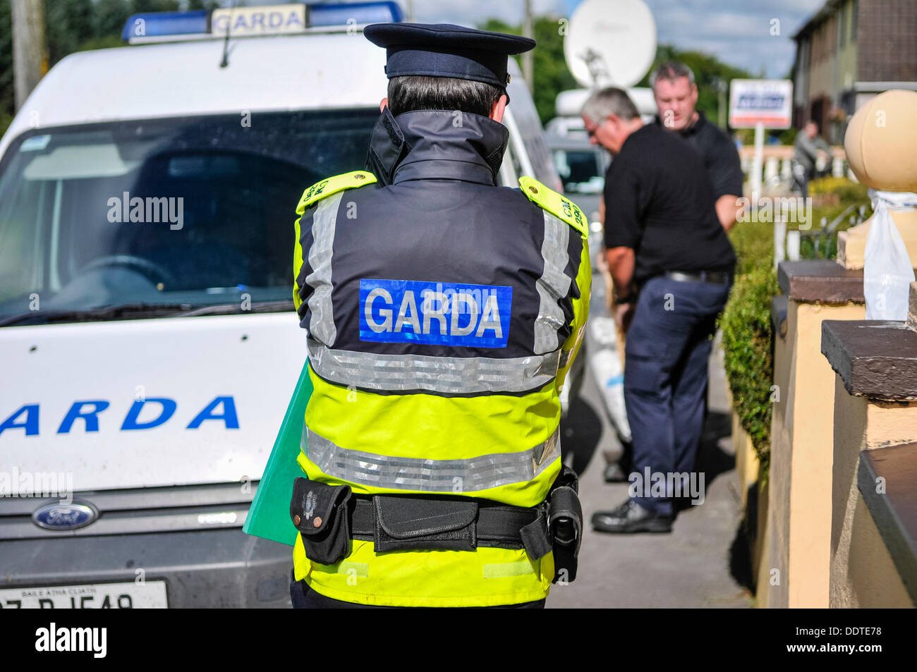 Bailieborough, County Cavan, Republic of Ireland, 6th September 2013 - A Garda officer watches two forensics officers outside the home of 54 year-old Patricia Kierans where her body was discovered.  She had been  'violently murdered' Credit:  Stephen Barnes/Alamy Live News Stock Photo