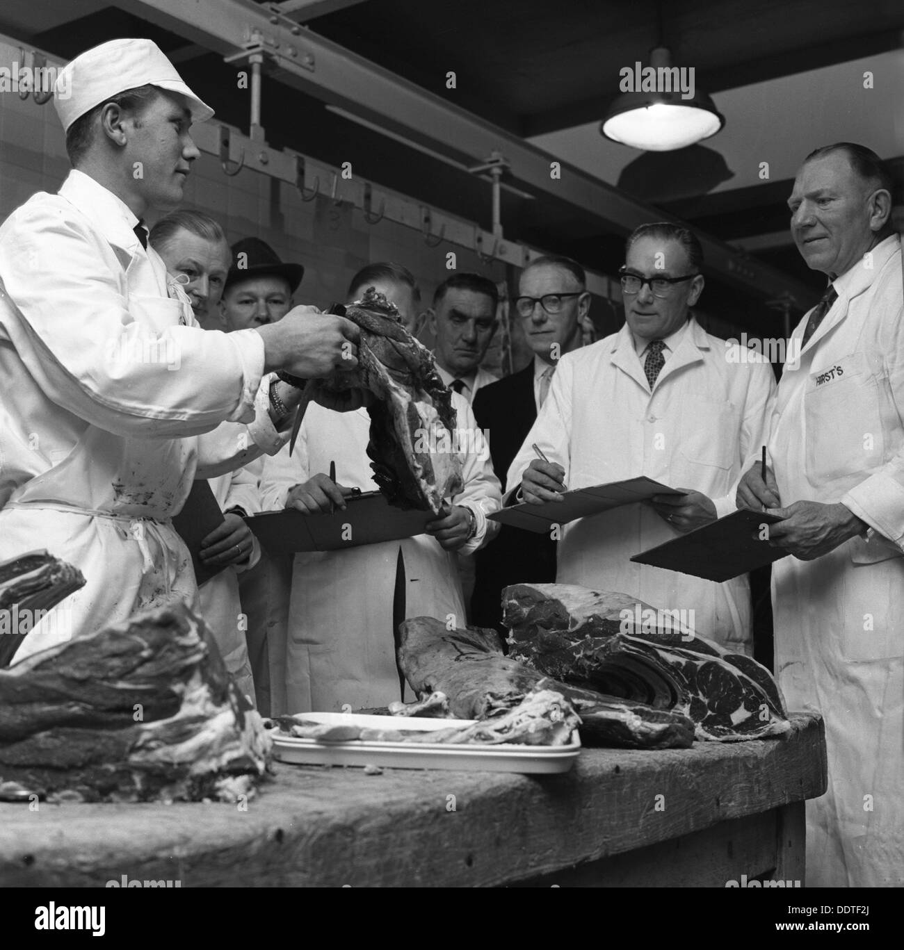 Apprentice butcher showing his work to competition judges, Barnsley ...
