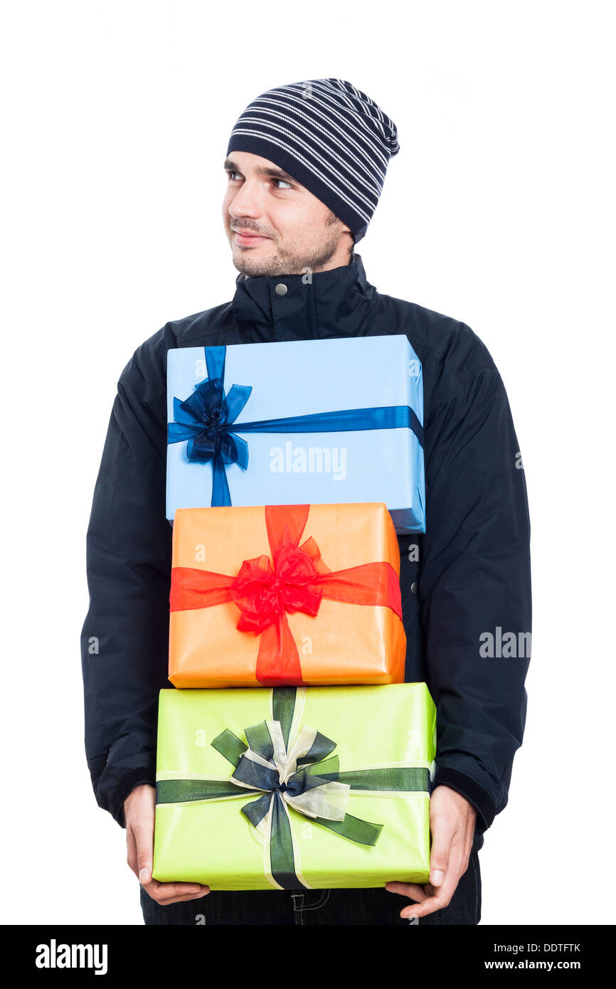 Satisfied man in winter jacket carrying presents, isolated on white background. Stock Photo