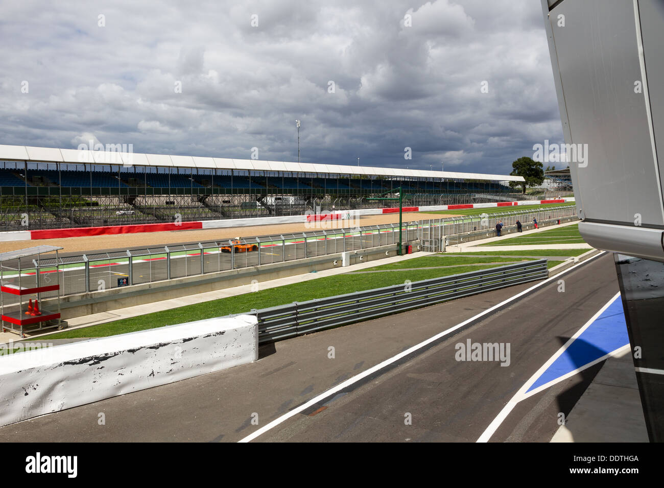 The Start / Finish straight at Silverstone Racing Circuit, including the grandstand and pit lane, taken from the podium. Stock Photo