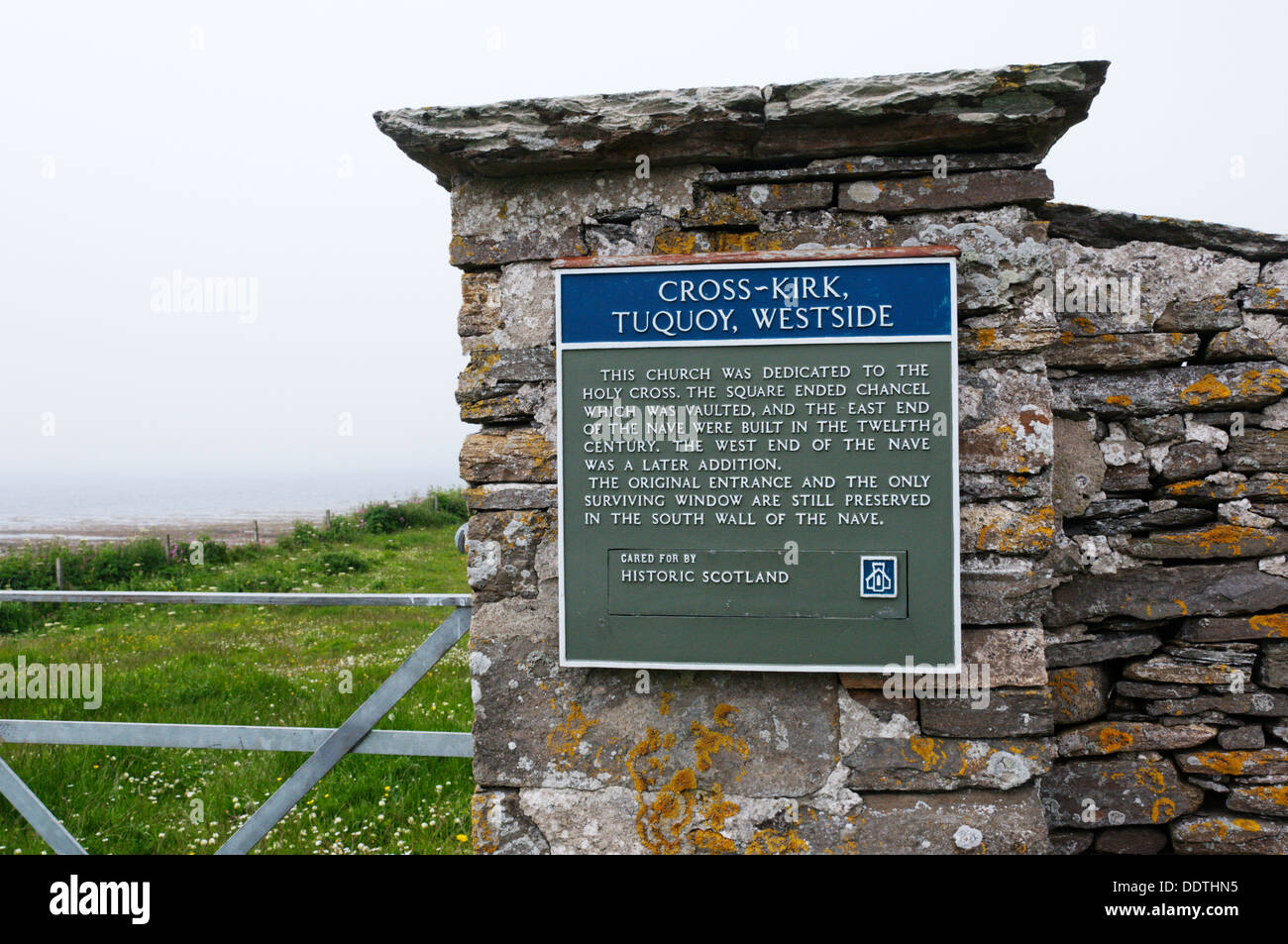 A sign at the entrance to the remains of the 12th century Norse Cross Kirk church at Tuquoy on Westray, Orkney. Stock Photo