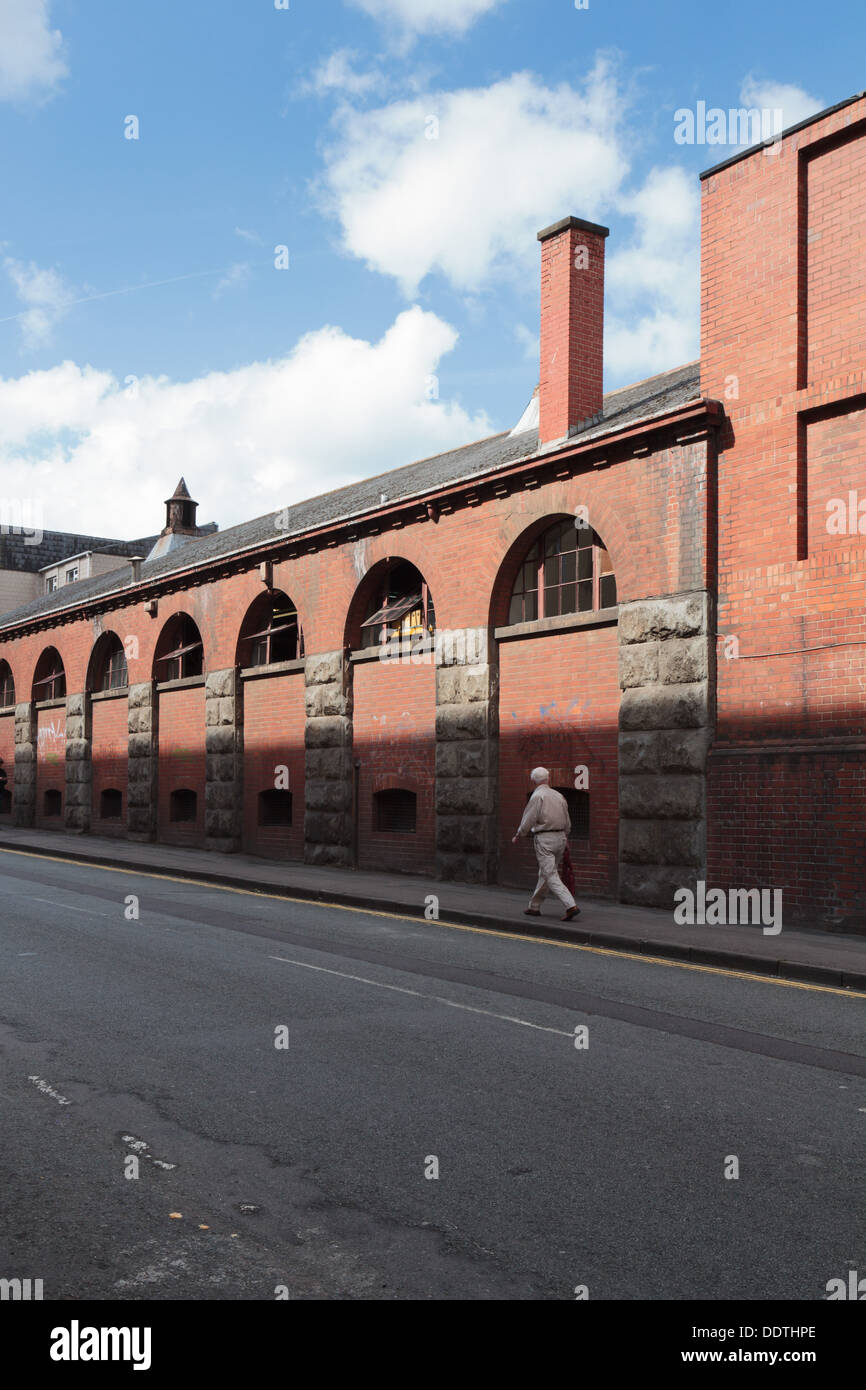 Victorian industrial factory building with stone piers, brick arches and tall chimney in Bristol. Stock Photo