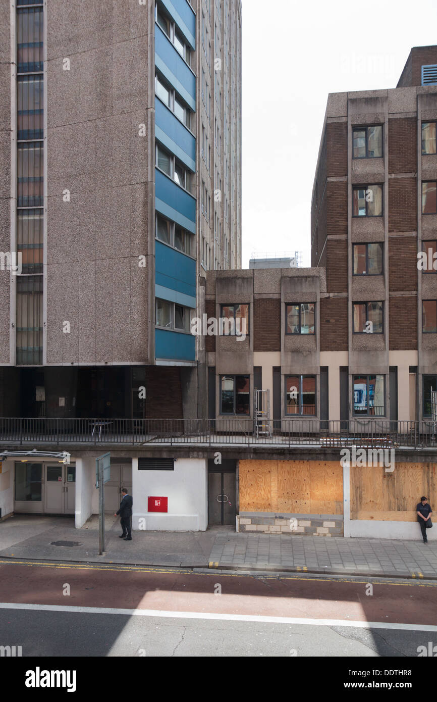 Modern 1960s office buildings in Bristol with boardedup shops below