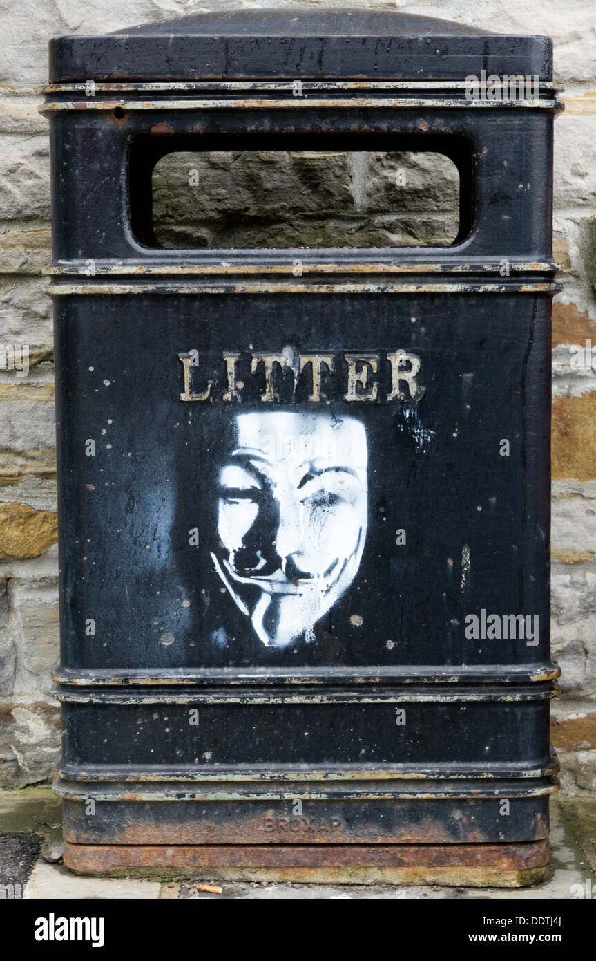Stencil graffiti face on a litter bin. Stock Photo