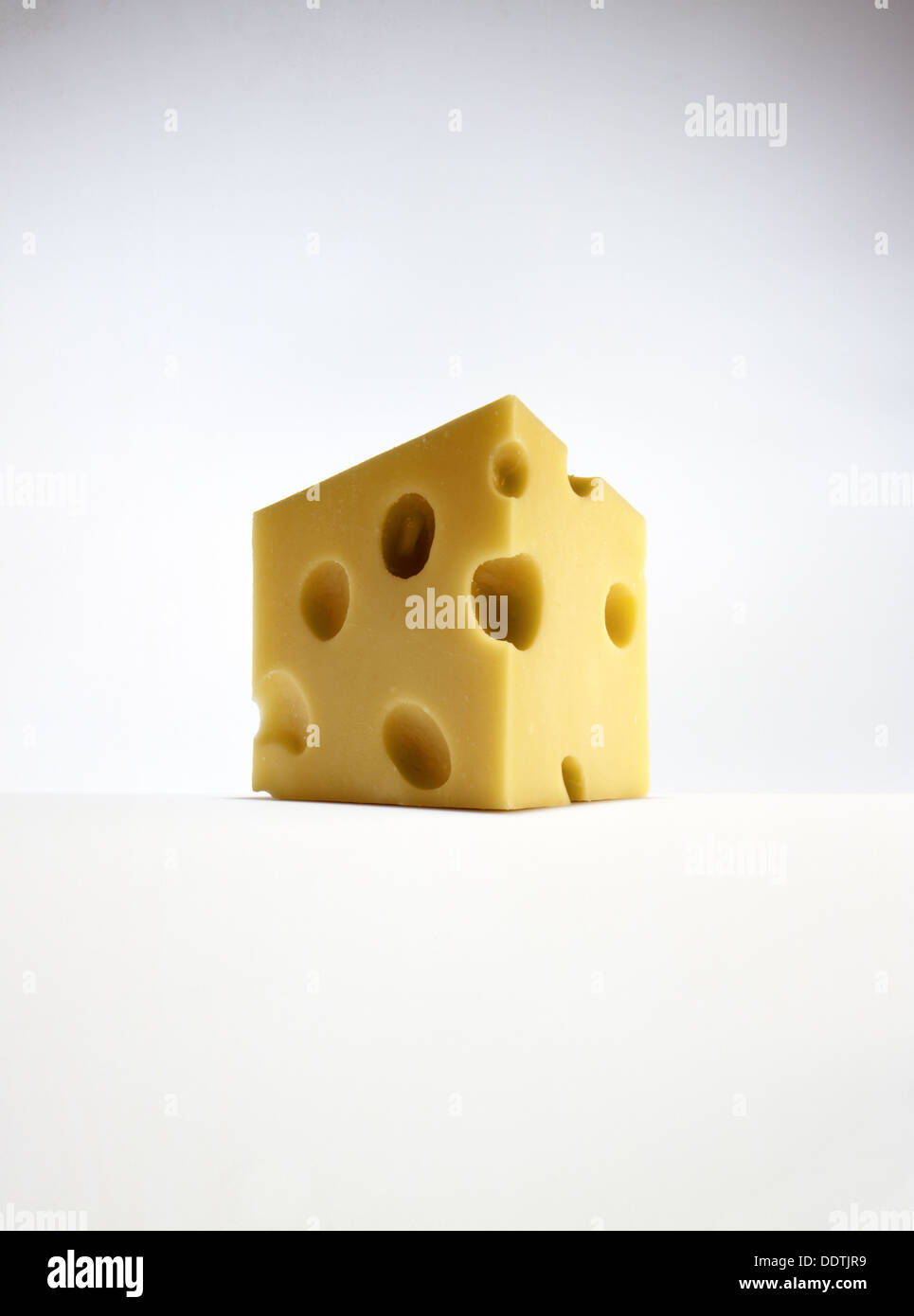 Swiss Cheese triangle on white Stock Photo
