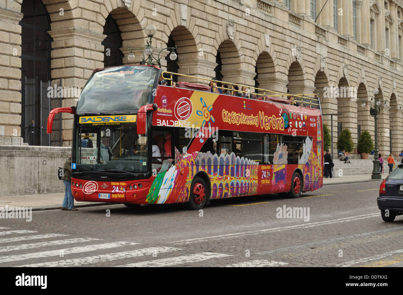An open top City Sightseeing bus prepares for another tour of Verona at Piazza Bra. Stock Photo