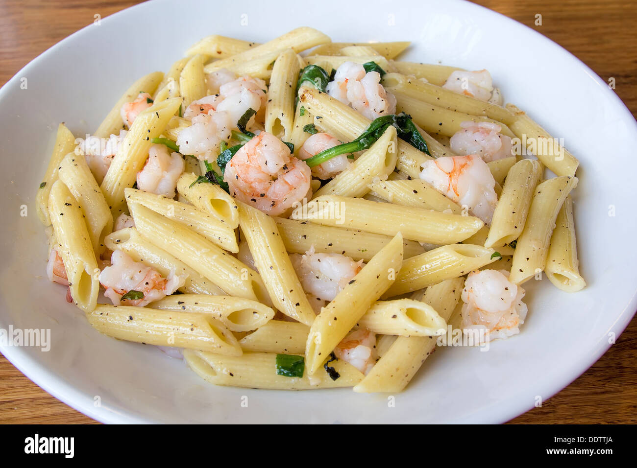 Prawns Spinach and Basil Tossed with Penne Pasta with Olive Oil Stock Photo