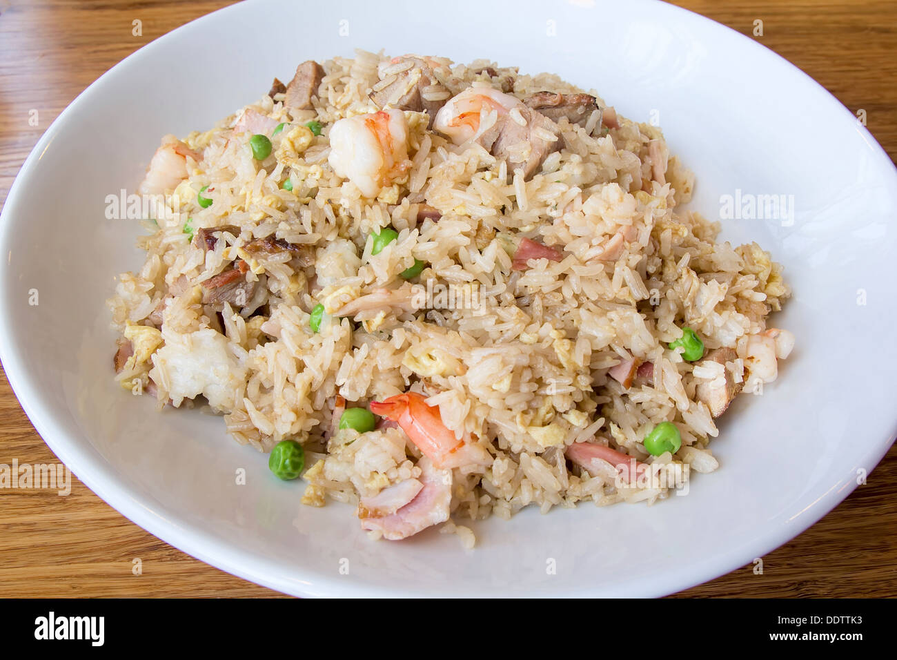 Yeung Chow Fried Rice with Barbecued Pork Prawns Green Peas Scallions and Eggs Stock Photo