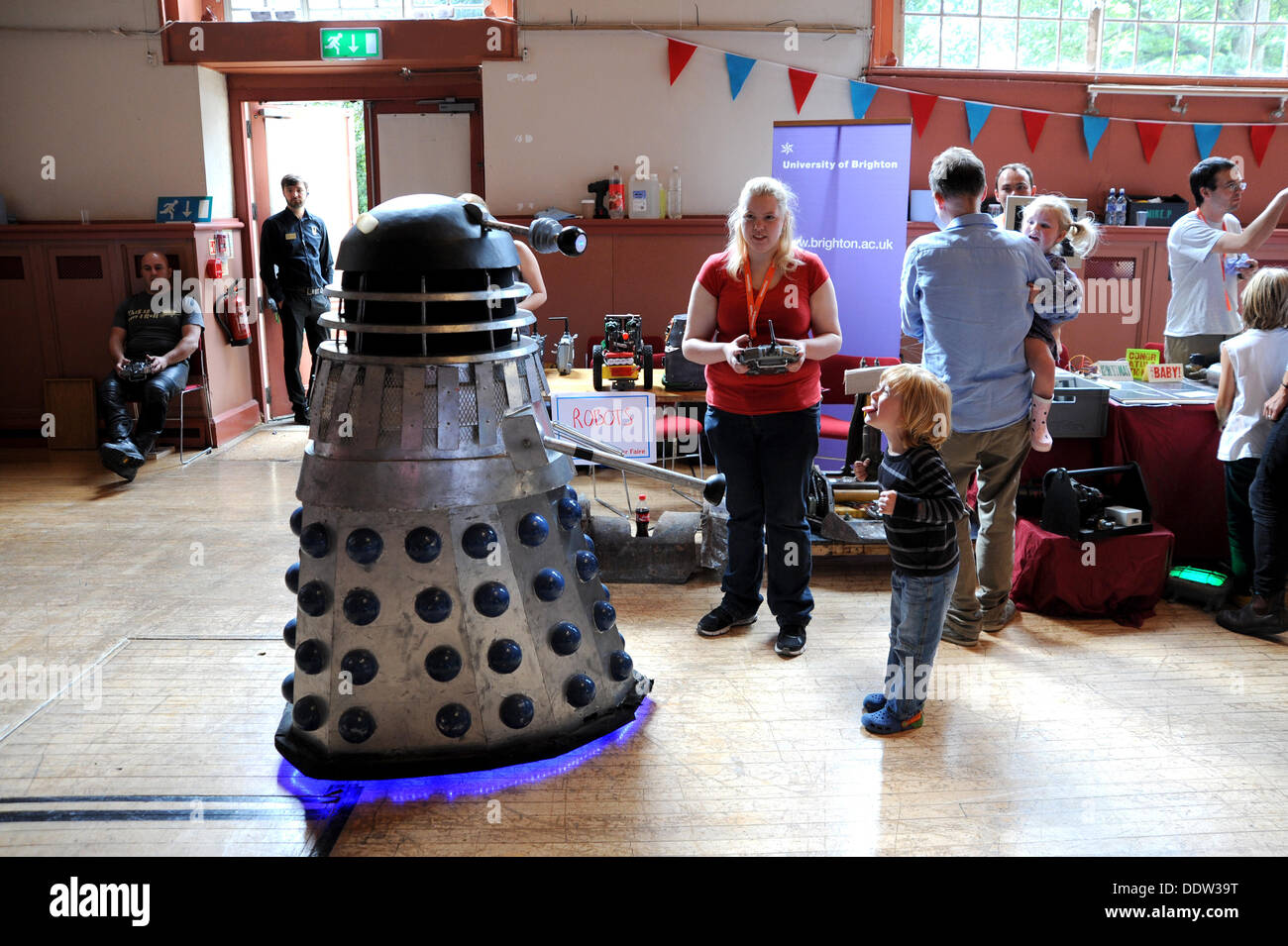 A Dalek from the TV series Dr Who meeting members of the public of all ages at the Mini Maker Faire held in the Corn Exchange Brighton Stock Photo