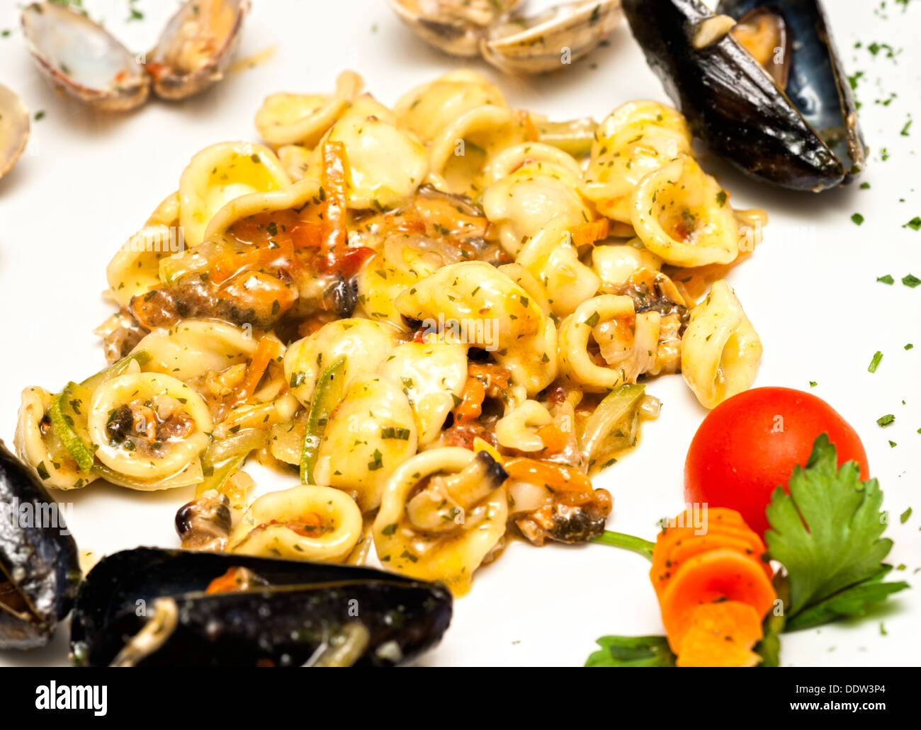 Tasty Orecchiette pasta with mussels, clams and vegetables. Stock Photo