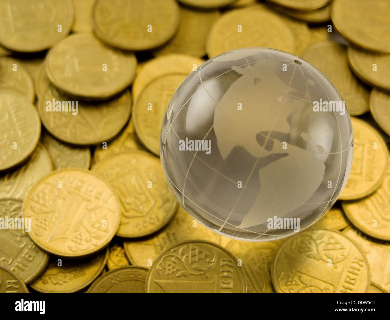 Close-up photo of crystal globe on gold coins Stock Photo