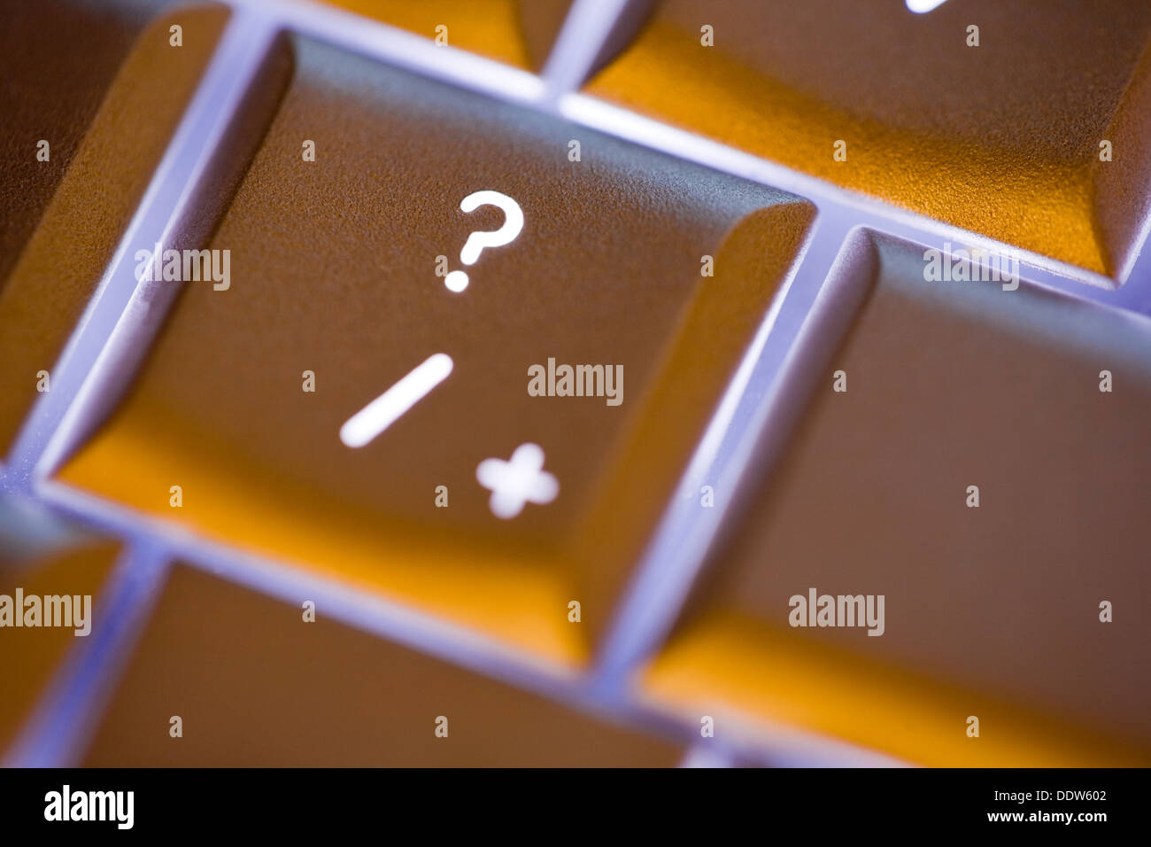 Close up of the question mark on an illuminated computer keyboard Stock Photo