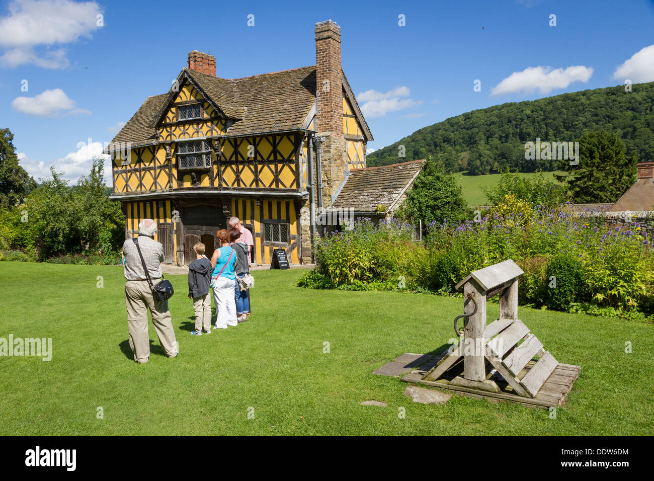 Visitors outside the timber framed gatehouse at Stokesay Castle in Shropshire. Stock Photo