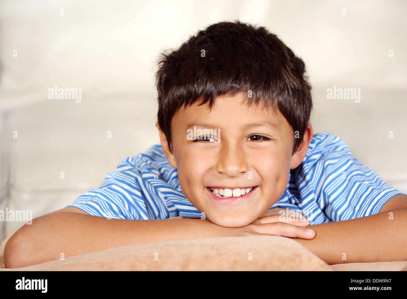 Smiling young boy watching TV  Stock Photo