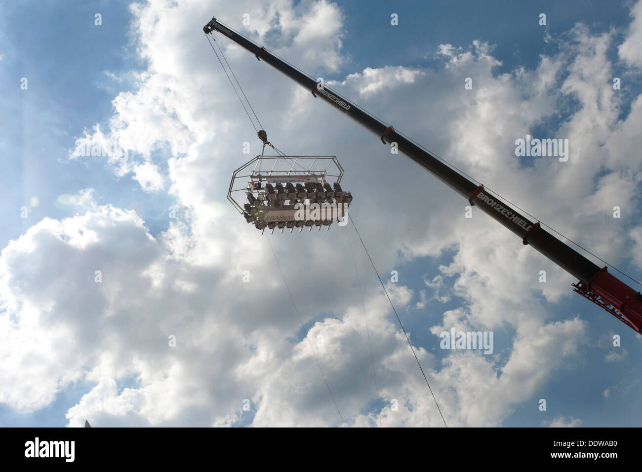 A British Airways high-flying dining table dangling from a crane 100 foot high in the sky above Brighton and Hove beach. Stock Photo