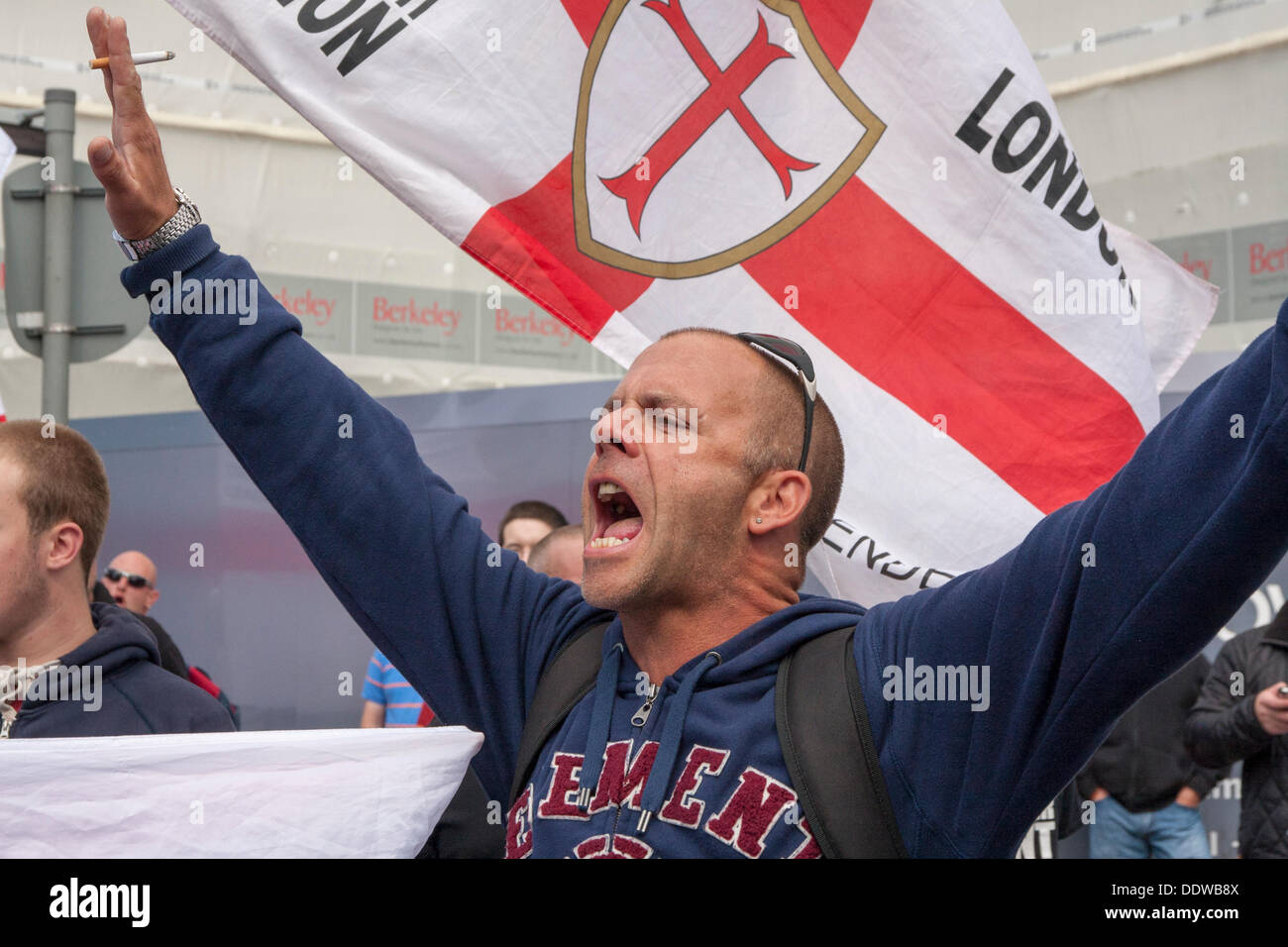 London, UK. 07th Sep, 2013. An EDL supporter chants slogans as several hundred English Defence League supporters marched over Tower Bridge to a short rally outside Aldgate station on the edge of the borough of Tower Hamlets. Credit:  Paul Davey/Alamy Live News Stock Photo