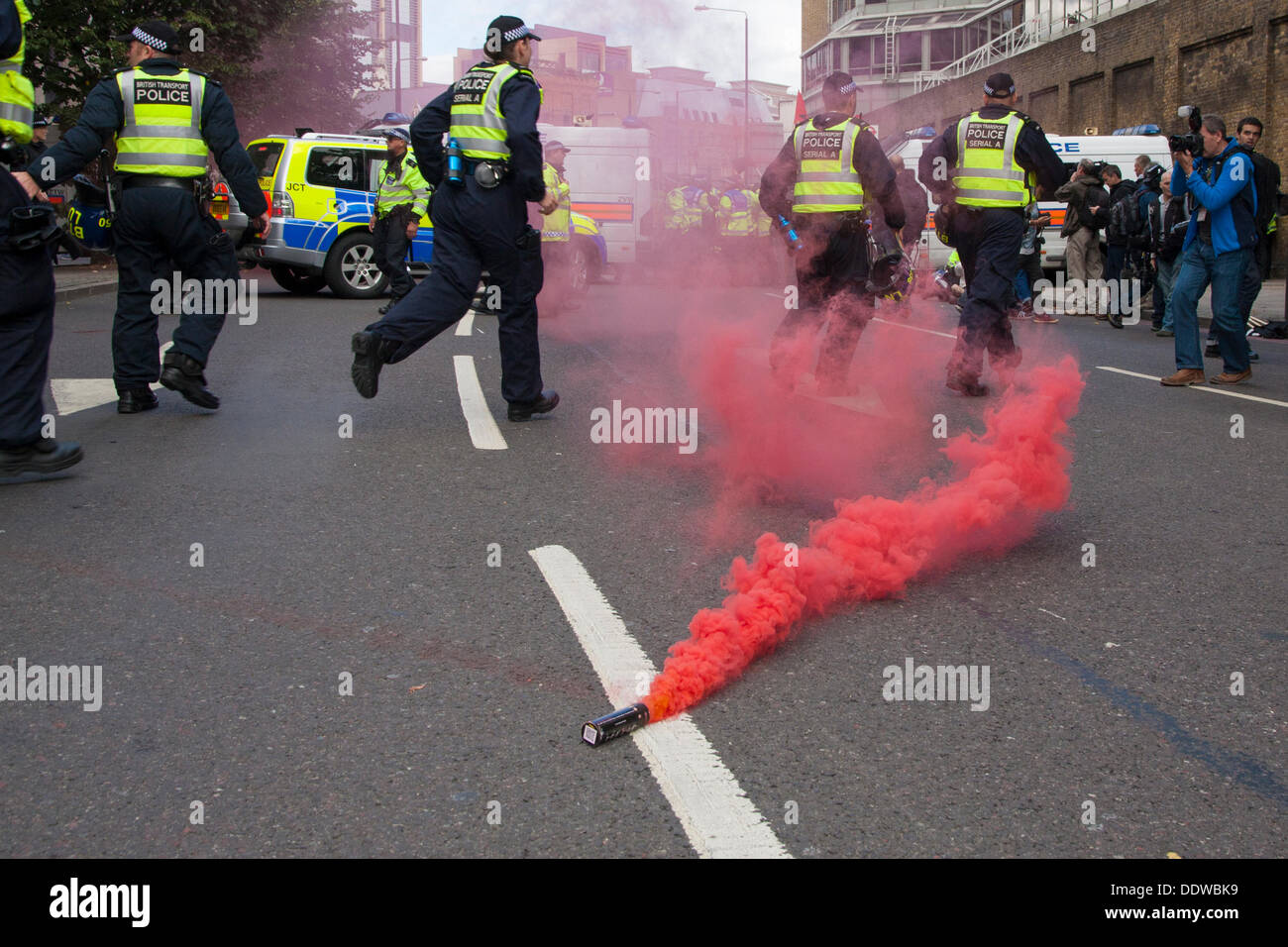 London, UK. 07th Sep, 2013. Police rush to intervene as anti-fascism counter protesters try to disrupt several hundred English Defence League supporters marching over Tower Bridge to a short rally outside Aldgate station on the edge of the borough of Tower Hamlets. Credit:  Paul Davey/Alamy Live News Stock Photo