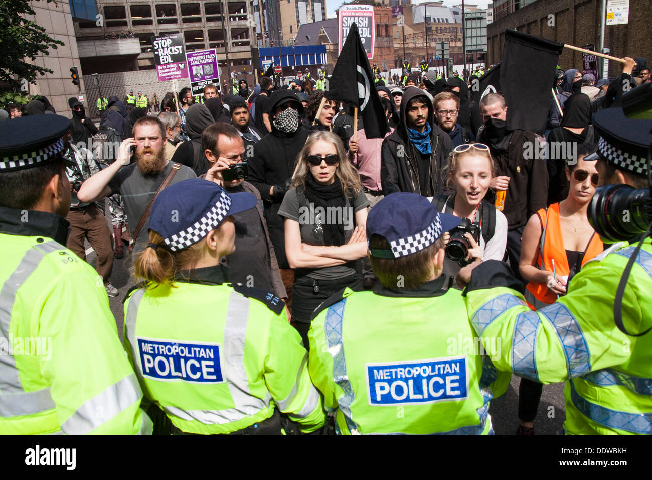 London, UK. 07th Sep, 2013. A small group of counterprotesters is hemmed in by police as several hundred English Defence League supporters marched over Tower Bridge to a short rally outside Aldgate station on the edge of the borough of Tower Hamlets. Credit:  Paul Davey/Alamy Live News Stock Photo