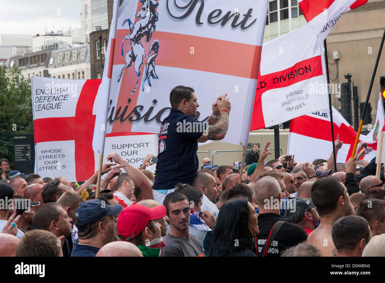 London, UK. 07th Sep, 2013. A man shoots speeches from atop his friend's shoulders as several hundred English Defence League supporters marched over Tower Bridge to a short rally outside Aldgate station on the edge of the borough of Tower Hamlets. Credit:  Paul Davey/Alamy Live News Stock Photo