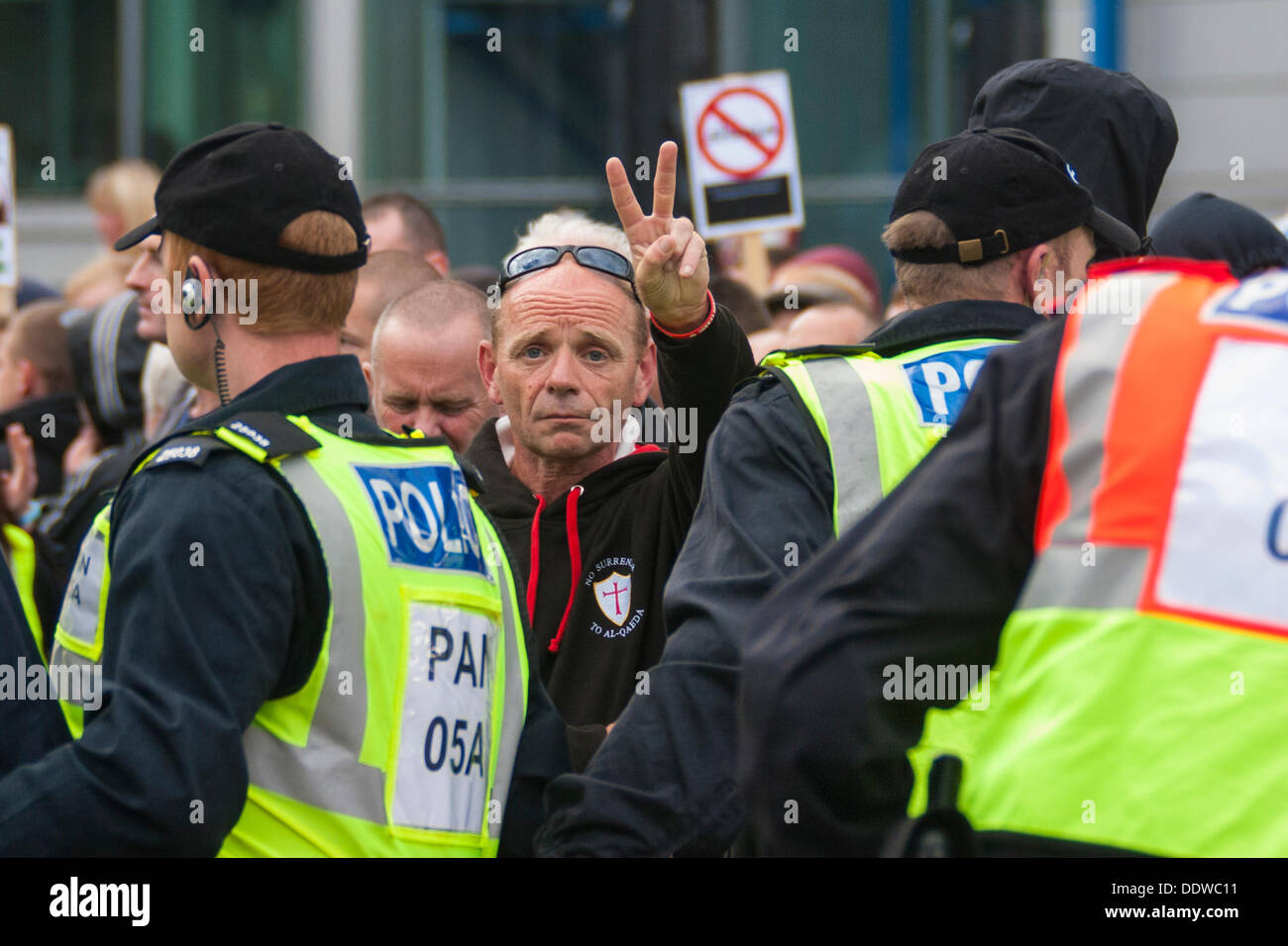 London, UK. 07th Sep, 2013. A man makes a 'V' sign for the camera as several hundred English Defence League supporters marched over Tower Bridge to a short rally outside Aldgate station on the edge of the borough of Tower Hamlets. Credit:  Paul Davey/Alamy Live News Stock Photo