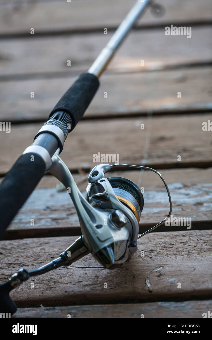 close up of fishing rod reel on a dock Stock Photo