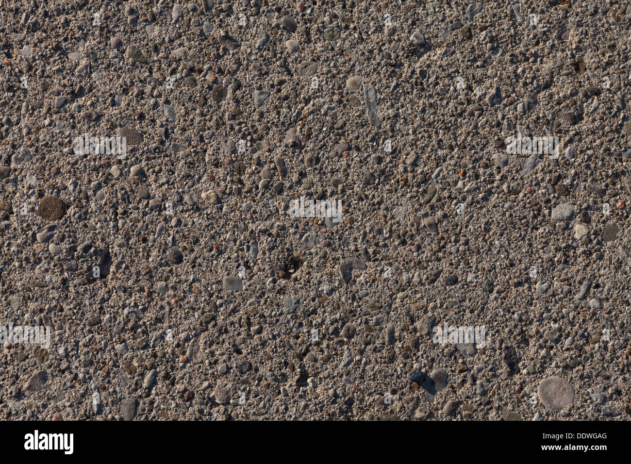 texture of a concrete surface embedded with pebbles. Stock Photo