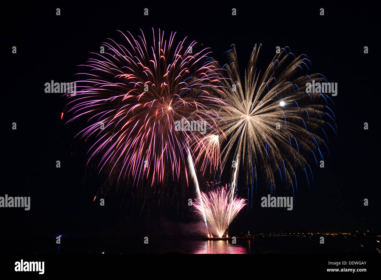 fire works fire crackers at night over the water Stock Photo