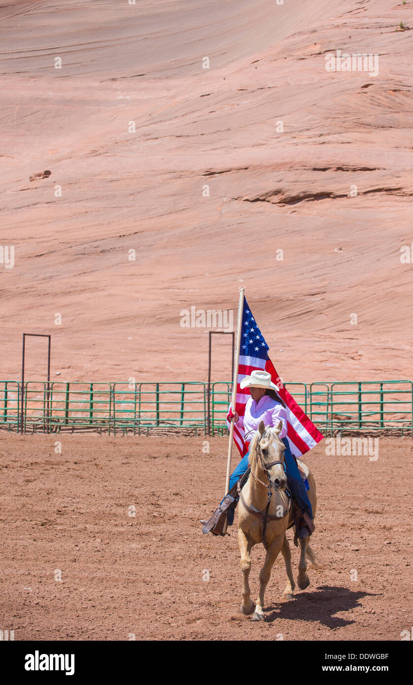 Cowgirl with American flag at the Opening Ceremony of the 92nd annual Indian Rodeo in Gallup Stock Photo