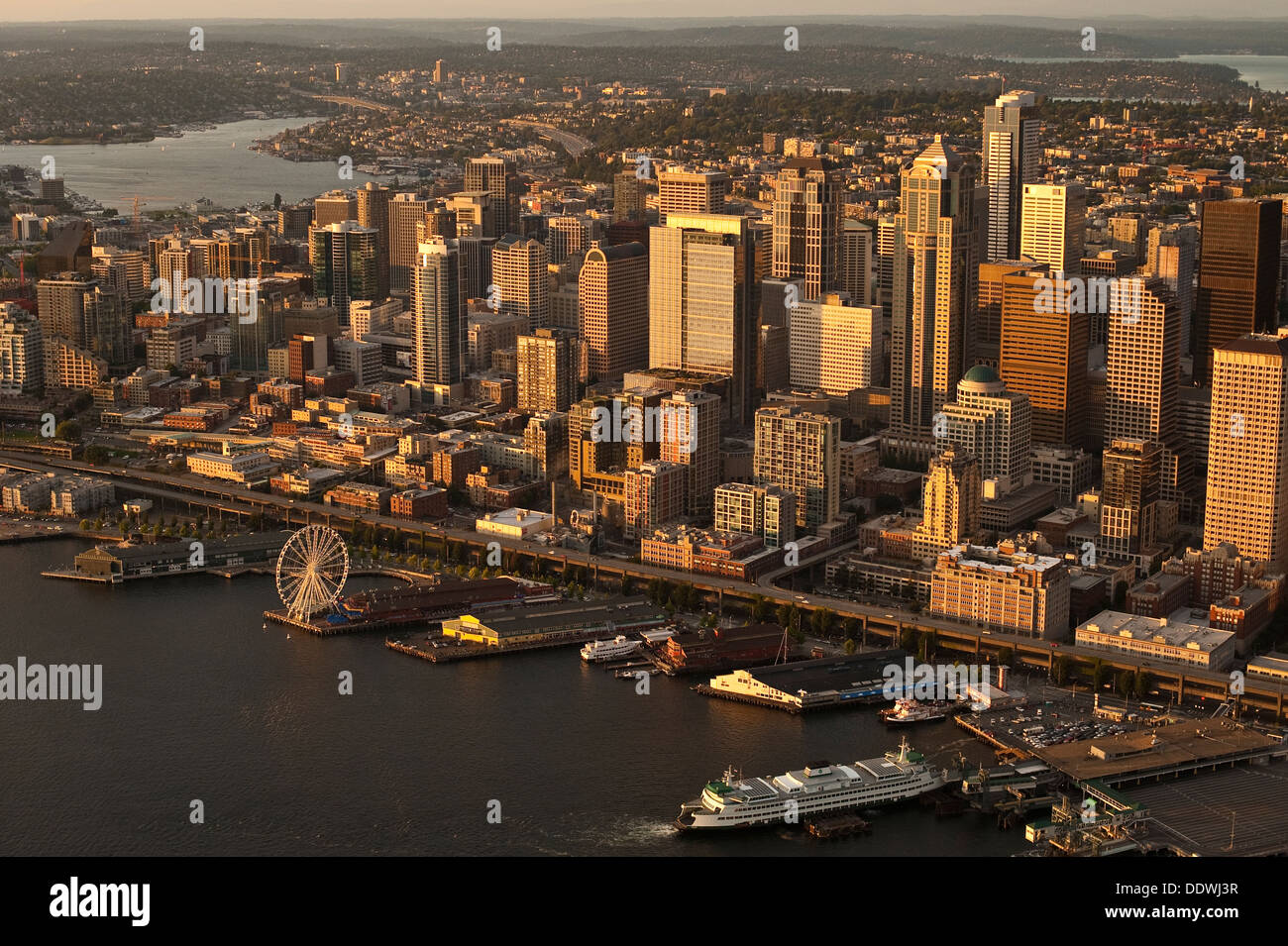 Aerial view of Seattle Skyline along waterfront with ferry boat at pier ...