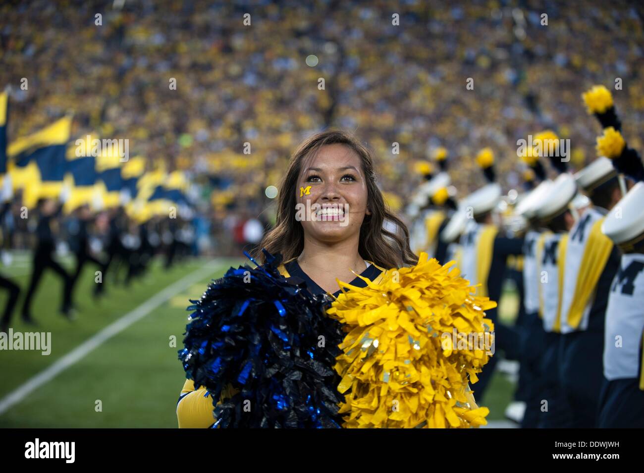 Ann Arbor, Mi, USA. 7th Sep, 2013. September 7, 2013: A cheerleader performs in front of the crowd during the NCAA Football game between the Notre Dame Fighting Irish and the Michigan Wolverines at Michigan Stadium, Ann Arbor, Michigan Seth Graves/CSM/Alamy Live News Stock Photo