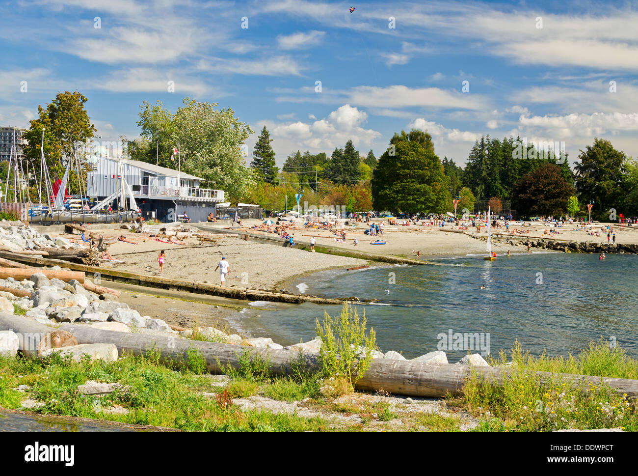 Sunbathers enjoying the sandy beach at Ambleside Park in West Vancouver, British Columbia, Canada. Beautiful summer day. Stock Photo